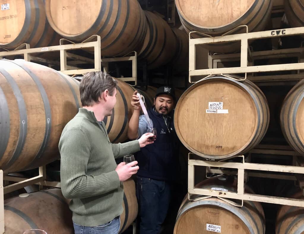 Scribner Bend Vineyards Winemaker pulls a sample from a barrel of Tempranillo for a Wine Club member.